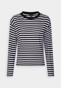 Svartvit randig långärmad t-shirt med rundad halsringning, som har ett mjukt tyg och en åtsittande silhuett.