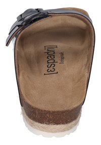 Black leather slide sandal with a textured cork footbed, white rubber sole, and a prominent buckle accent. Inner lining is soft and beige.