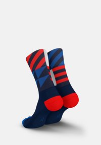 Multicolored socks featuring a geometric design with red, blue, and navy stripes. Soft fabric with reinforced red heel and toe accents.