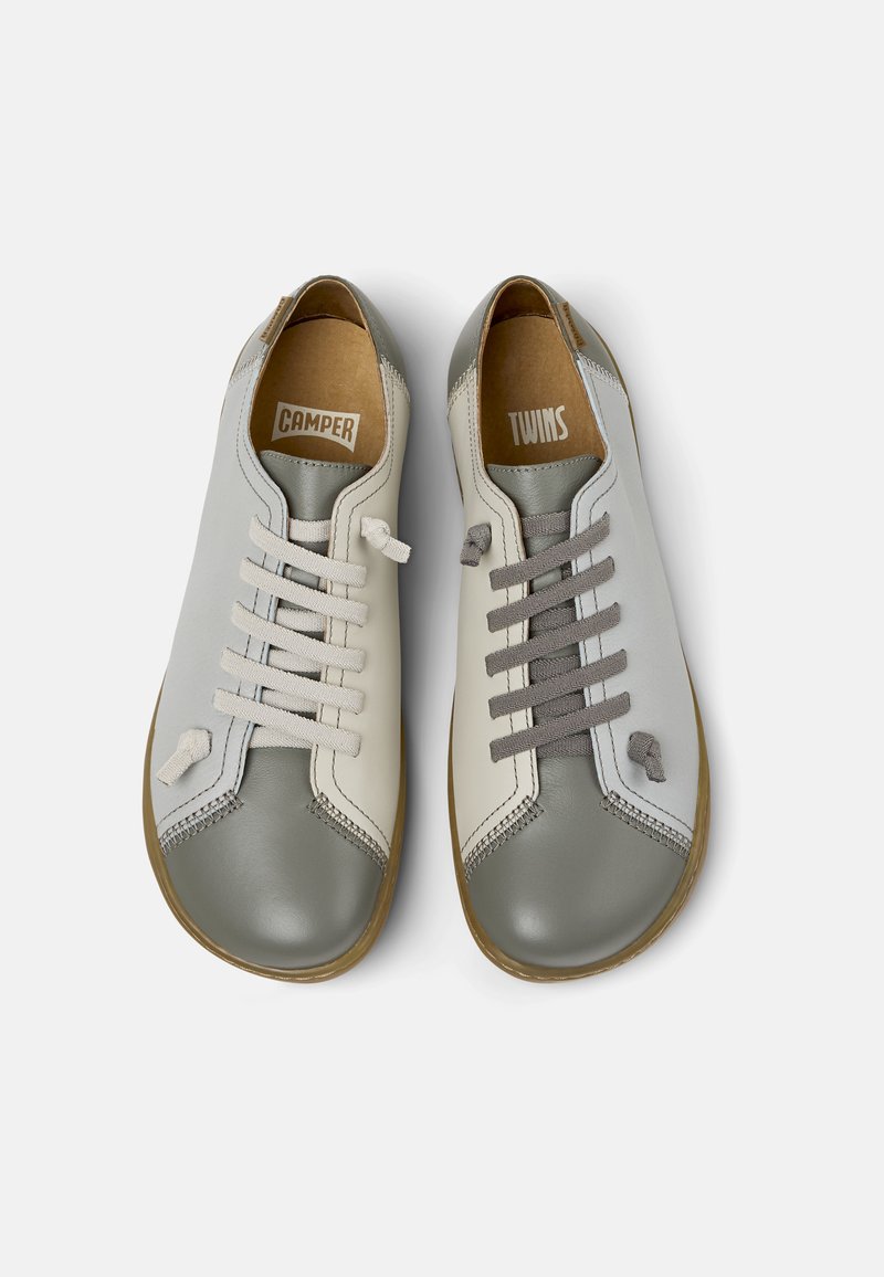 Gray and beige leather shoes with round toes, featuring distinct laces and contrast stitching. Interior labels read "CAMPER" and "TWINS."