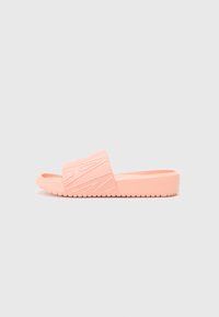 Pink slide sandal made of textured rubber, featuring an embossed design on the strap and a flat sole with a textured grip pattern.