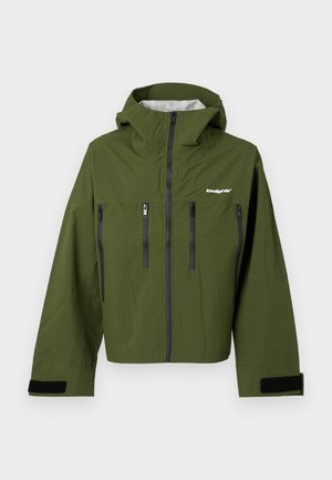 Grønn vanntett jakke med hette, med to glidelåslommer på brystet og justerbare mansjetter med borrelås. Glatt tekstur, slank design.