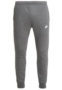 Šedé bavlněné tepláky s elastickým pasem a žebrovanými manžetami, s malým bílým logem Nike na levém stehně.