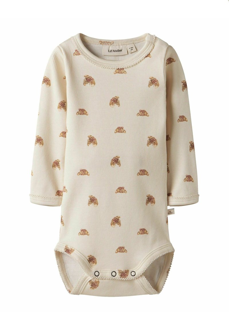 Långärmad baby bodysuit i krämfärgad ribbad tyg, med ett spritt mönster av croissanter och tryckknappar nedtill.