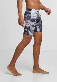 Boxeri cu un design grafic alb și negru, având motive de cranii și bani. Banda elastică cu logo; formă ajustată.