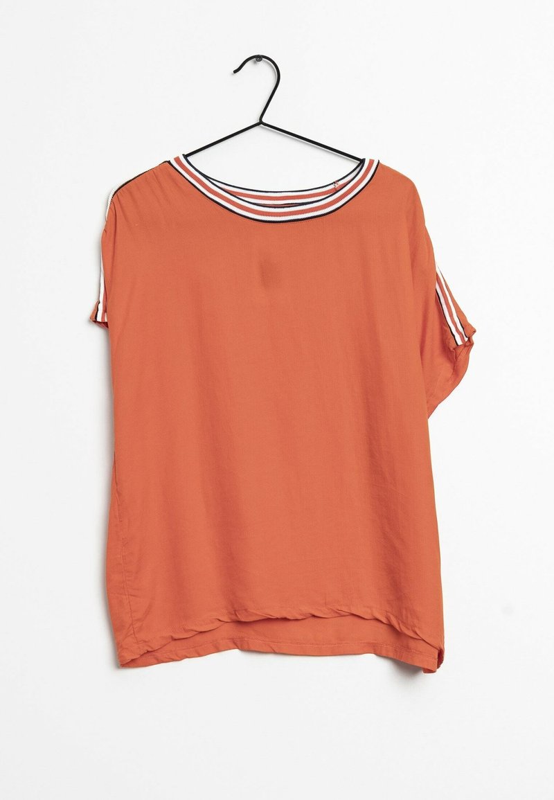 Loose short-sleeve orange blouse with white and black striped collar and sleeve trim, hanging on a black hanger against a white background.