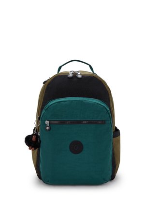 Backpack with black, green, and olive sections, front zip pocket, double zipper, side pockets, top handle, and plush monkey keychain hanging on side.