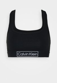 Zwarte katoenen sportbeha met een vierkante halslijn en brede banden. Kenmerkt een witte logoband aan de onderkant. Zachte textuur, minimalistisch design.