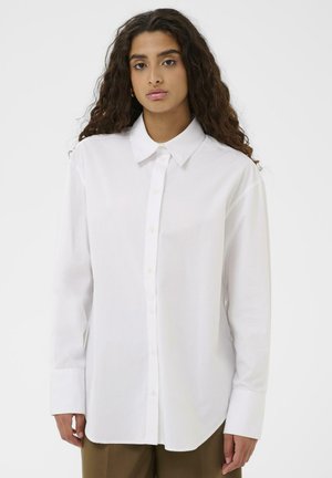 Weißes Langarmhemd mit spitzem Kragen, Knopfverschluss und Manschettenärmel. Glatte Textur mit lockerem Schnitt. Keine Muster oder Verzierungen.