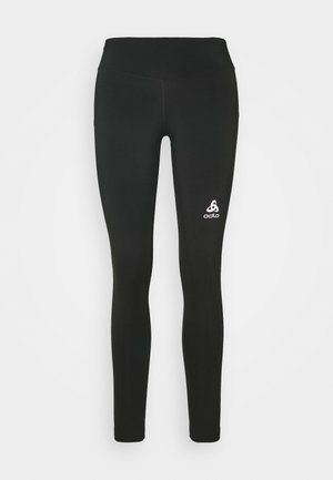 Black leggings made from stretchy fabric with a high waistband. Features a white logo at the lower left leg. Smooth texture, fitted design.
