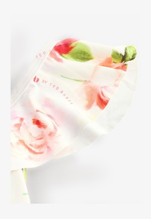 Õie mustriga kangas roosades, rohelistes ja valgetes toonides. Omab siledat tekstuuri pehme ja voolava disainiga. Sisaldab kaubamärgi logo.