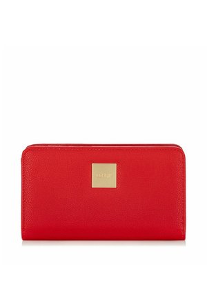 Czerwony portfel zapinany na zamek z centralną, złotą kwadratową plakietką z wytłoczonymi inicjałami marki.