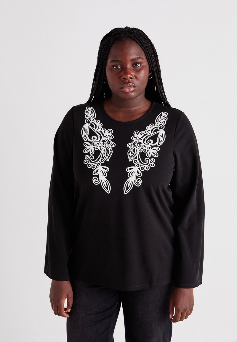 Black long-sleeve shirt featuring white floral embroidery on the chest. Smooth fabric with a relaxed fit and round neckline.