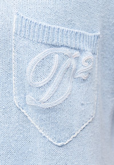 Ανοιχτό μπλε πλεκτό ύφασμα με μια μικρή τσέπη που έχει ανάγλυφο κεντημένο "D²" με νήμα ίδιου χρώματος.