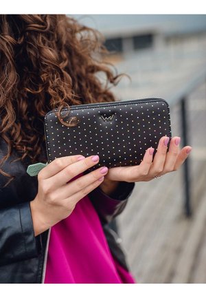 Schwarze Reißverschlussbörse mit mehrfarbigen Punkten und einem strukturierten grünen Akzent. Sie besteht aus Leder, hat eine glatte Oberfläche und ein Logodesign.