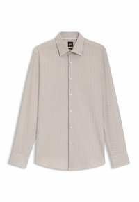 Pitkähihaisessa vaaleanbeigessä paidassa on pieni tummansininen ja punainen geometrinen kuvio. Paidassa on nappikaulus ja etunappisulku.