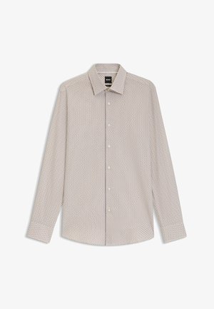 Koszula z długim rękawem w jasnym beżu z małym geometrycznym wzorem w kolorze granatowym i czerwonym. Posiada kołnierz zapinany na guziki oraz zapięcie na guziki z przodu.