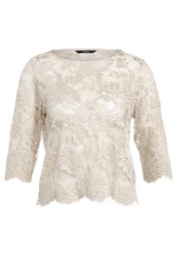 Top in pizzo con scollo rotondo, maniche a tre quarti e motivo floreale. Colore beige chiaro con orlo scalloppato e superficie testurizzata.