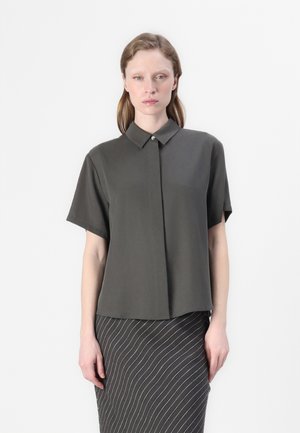 Short-sleeve, dark olive green shirt made of smooth fabric, featuring a button-down collar and a relaxed fit.