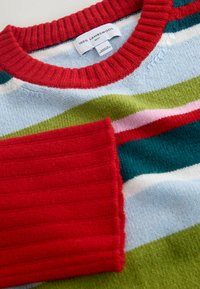 Lambswool sweater featuring a crew neck, with multicolored stripes in red, green, blue, and pink. Ribbed red cuffs add texture.