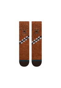 Rudos kojinės, papuoštos Chewbaccos veidu, su juodais akcentais ir pilkai balta pistoletų diržo raštu. Pagamintos iš minkštos, tekstūruotos medžiagos.