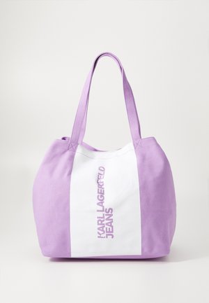 Purple canvas tote bag with double handles, featuring a white vertical stripe and "KARL LAGERFELD JEANS" printed in bold letters.