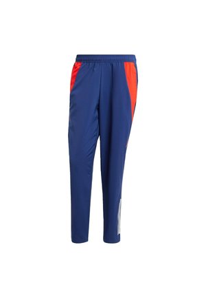 Navy blue athletic pants with red side panels, elastic waistband, and tapered legs. Features white stripes on the lower side of one leg.