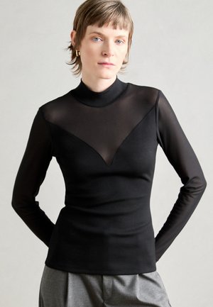 Black long-sleeve top with a mock neck, featuring a sheer panel in a V shape at the front and smooth, fitted fabric.