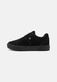 Sneakers bassi in suede nero con superficie texturizzata, lacci tono su tono e suola in gomma. Presentano un piccolo logo dorato di lato.