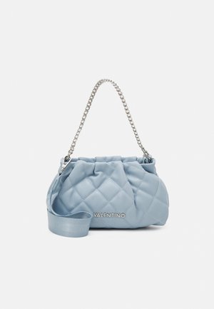 Light blue quilted handbag with silver chain handle, fabric strap, and "VALENTINO" logo on front against white background.