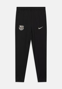 Black athletic pants with an elastic waistband, featuring a grey Nike logo and a FC Barcelona crest on the left thigh. Smooth, lightweight fabric.