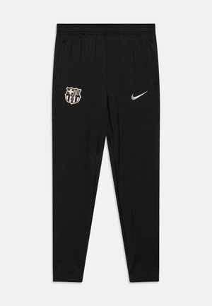 Black athletic pants with an elastic waistband, featuring a grey Nike logo and a FC Barcelona crest on the left thigh. Smooth, lightweight fabric.