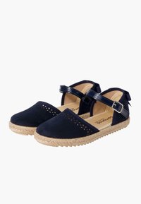 Navy blue espadrille shoes with perforated upper, adjustable ankle strap, and jute rope sole, featuring smooth suede texture.