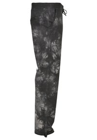Čierne a šedé tie-dye tepláky s jemným materiálom, elastickým pásom, šnúrkou na stiahnutie, bočnými vreckami a zúženými nohavicami so zipsami na koncoch.