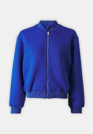 Blue zip-up bomber jacket with a ribbed collar, long sleeves, side pockets, and a textured fabric finish. Smooth zip closure in the front.