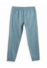Pantalon de jogging bleu clair fuselé avec taille élastique et poches latérales zippées, posé à plat sur fond blanc.