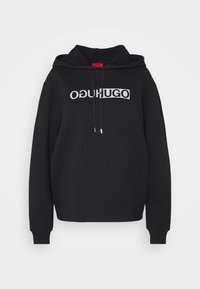 Černá mikina s kapucí a stahovací šňůrkou, na přední straně s velkým bílým logem "OɥUɡO". Měkký materiál, žebrované manžety a lem.