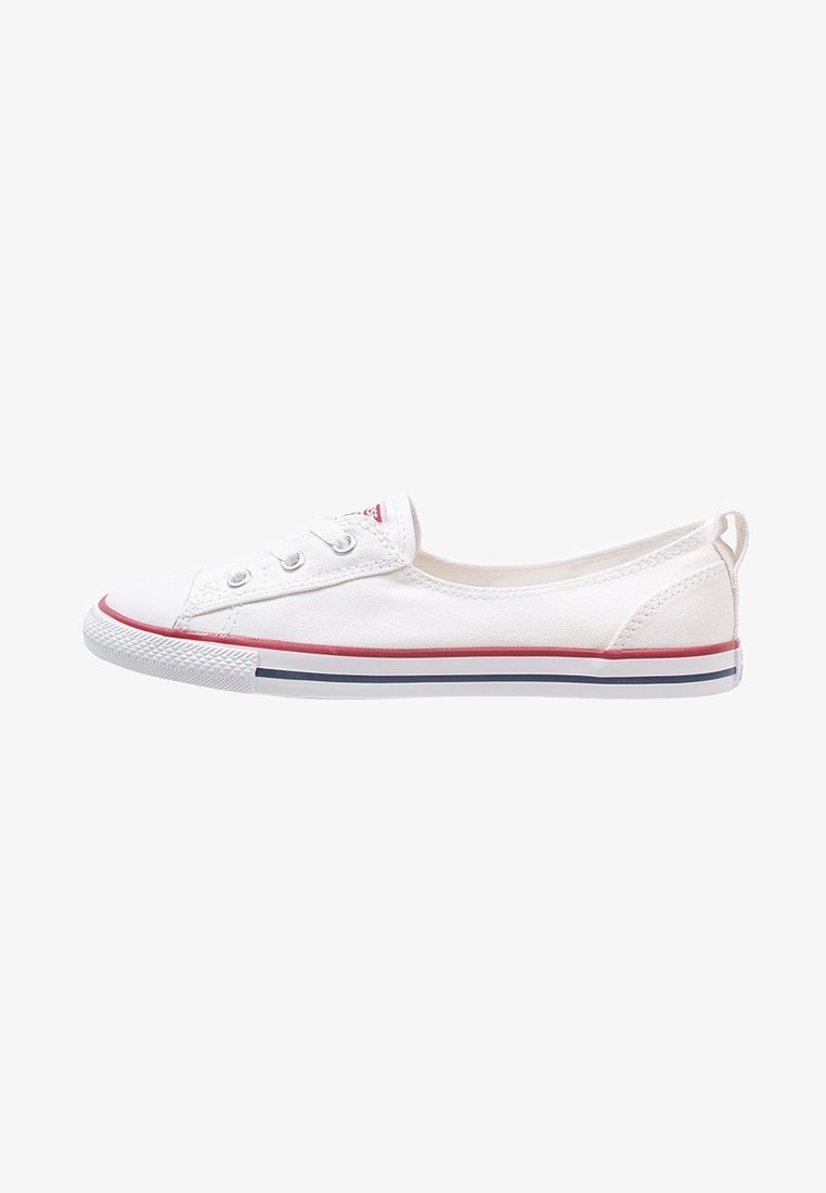 White low-cut canvas sneaker with red and blue striped rubber sole and metal eyelets for laces, viewed from the side.