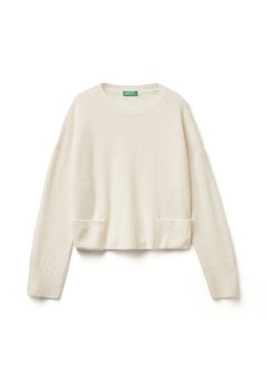 Maglione corto color crema con scollatura rotonda, polsini e orlo a coste. Texture morbida, vestibilità leggermente oversize con spalle scese.