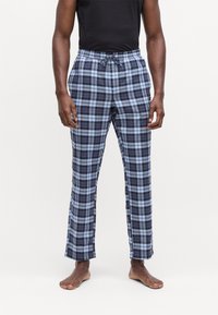 Karirane pidžama hlače u mornarsko plavoj i svijetloplavoj boji, s elastičnim pojasom i vezicom. Lagana tkanina s opuštenim krojem.