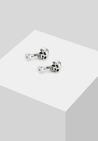 Silver skull cufflinks with detailed engraving, featuring a polished finish and a round base with a minimalist design accent.