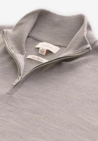 Light gray, 100% merino wool pullover with a quarter zip and ribbed collar; features brand tags inside at the neckline.