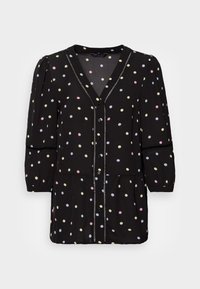 Blusa preta com decote em V, mangas três quartos e fecho de botão. O tecido é estampado com bolinhas multicoloridas e detalhes texturizados.