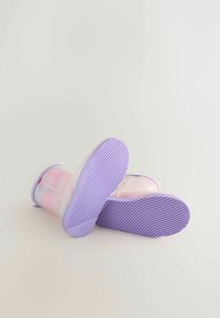 Purple-soled boots with a translucent upper featuring pastel colors and a smooth finish. Textured rubber outsole for grip.