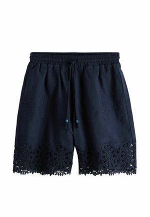 Navy blue shorts with elastic waistband, drawstring, and intricate lace detailing along the bottom hem.