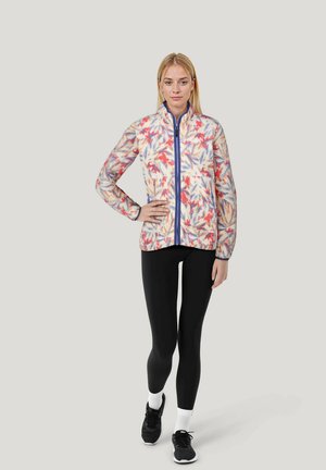 Fleece jacket with a floral pattern in red, blue, and orange tones, featuring a high collar and front zipper; paired with black leggings and sneakers.