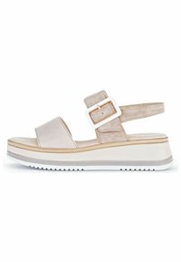 Beige wedge sandal featuring a smooth upper, a suede ankle strap with a rectangular white buckle, and a textured white outsole.