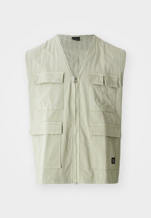 Khaki sleeveless vest with a zip closure and four pocket design. Made from lightweight fabric, featuring a V-neckline and subtle texture.