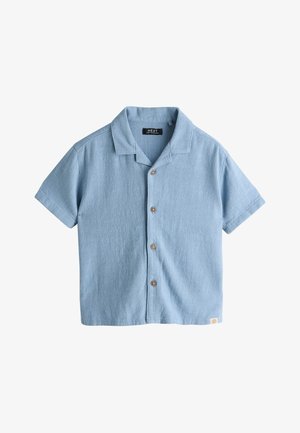 Hele sinine lühikeste varrukatega nööbitav särk, tekstuurse kangaga, puidust nööpide ja väikese valge sildiga alumisel äärel.