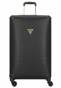Valise rigide noire en matériau texturé, arborant un logo triangulaire doré. Équipée d'une poignée télescopique et de quatre roues.